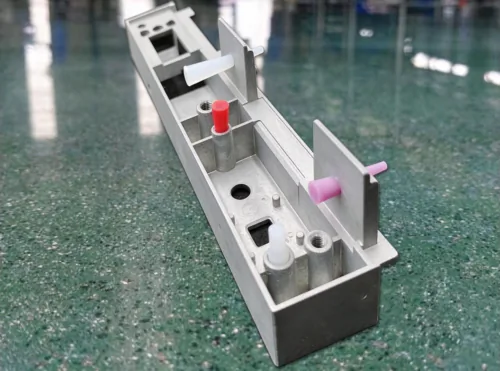 Assorted tapered silicone masking plugs installed on aluminum profile for anodizing